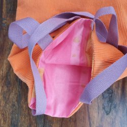 rosa stof invendig p� orange elccykelbatteritaske