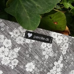 Forklde i sortgr voksdug med blomster