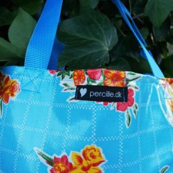 Taske mini i voksdug i lysebl nuancer